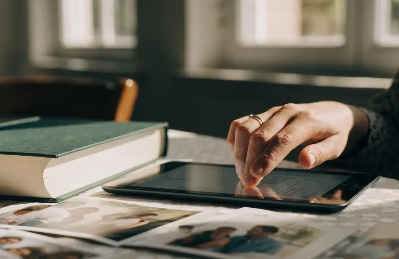 A person inviting more contributors to a memory book on a tablet