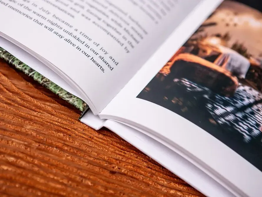 Close-up of an open Travel Book: the story on the left, a full-colour photograph on the right, printed on matte paper