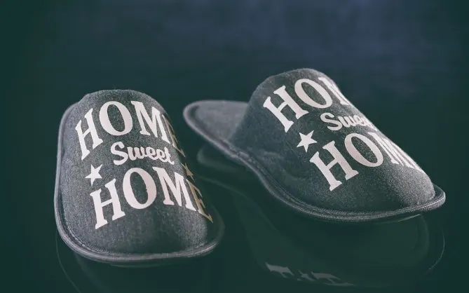 Pair of grey felt house slippers printed with Home sweet home