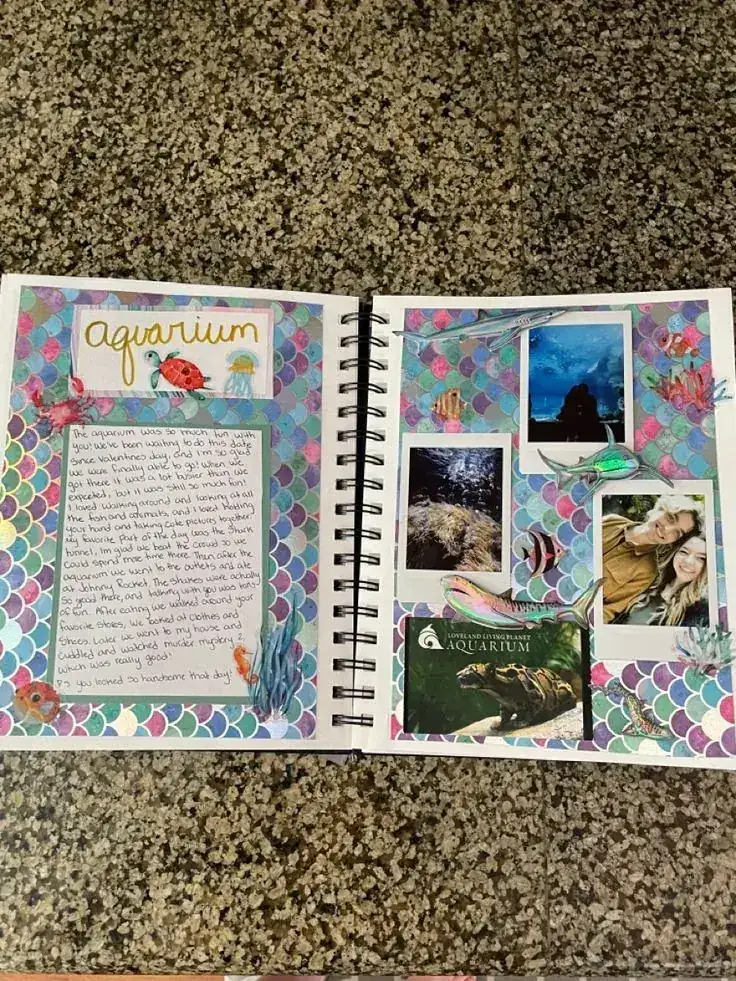 Scrapbook spread about an aquarium visit with fish stickers and instant photo prints