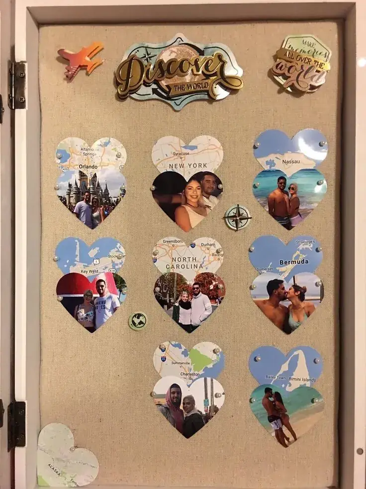 Framed pinboard of heart-shaped maps and holiday photos under the word Discover